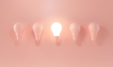 Glowing Light Bulb between the others on pastel coloredの写真素材