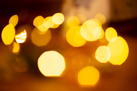 Bokeh style Golden lights out of focus on abstract background. Magic, fantastic, festive concept.