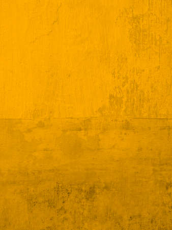 Stucco wall painting gold yellow. Background modern textured rusty wallpaper. Vertical size.