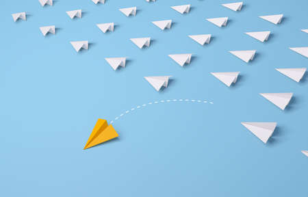 Individual and unique leader yellow paper airplane changing direction on blue background. 3d...