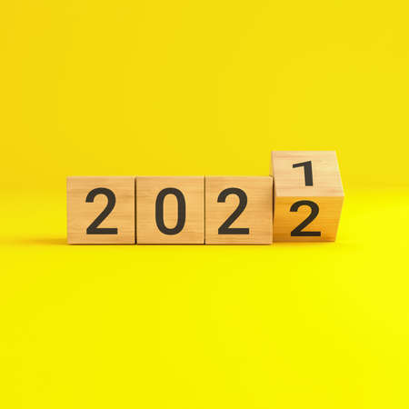 Flip over wooden cube block with new year 2022 on yellow background. 3D illustration.
