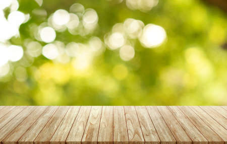 Empty wooden table on outdoor forest blurred background, assembly, product display exhibition.