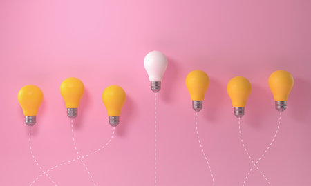 Light bulb outstanding among yellow lightbulb group on pink background. Innovation unique think...