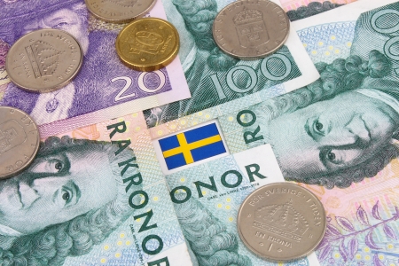 An arrangement of Swedish Kroner notes, coins and flag の写真素材
