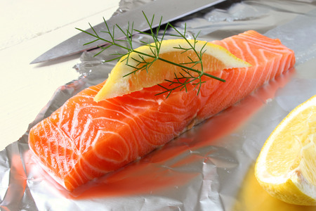 A raw fresh Salmon fillet, lemon slice and dill の写真素材