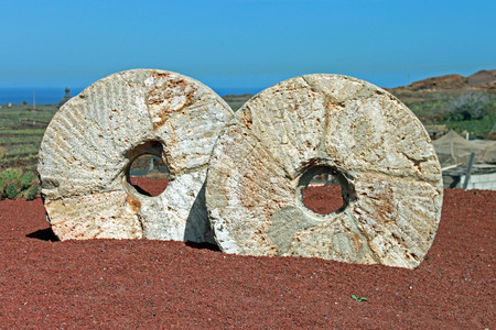 Two old millstones set into a volcanic landscape in the Canary Islands の写真素材