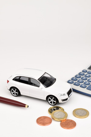 A white car on a white background with Euro coins and calculator.の写真素材