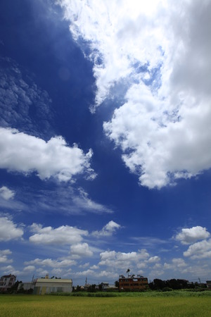 Under sunny blue sky and white cloudsのeditorial素材