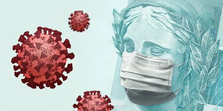 Concept for economic impact of the coronavirus pandemic. Brazilian Real - BRL currency banknote face wearing a mask besides floating viruses.の写真素材