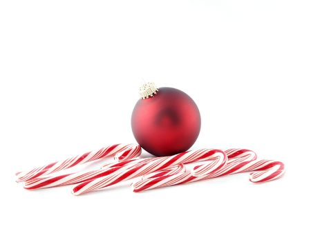 Candy canes with a red ballの写真素材