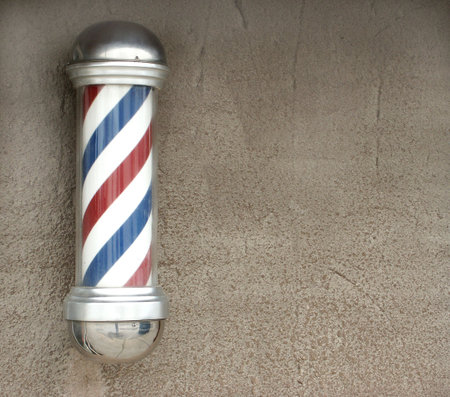 White, blue, and red vintage barber's poleの写真素材