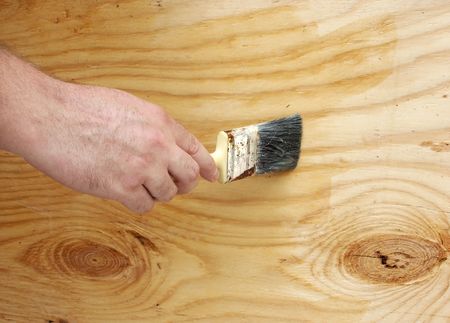 A man's hand with a paint brushの写真素材