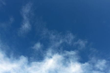 Puffy white clouds on a blue skyの写真素材