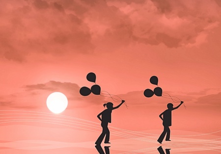 Silhouette of children with balloonsの写真素材