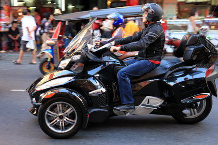 BANGKOK - JANUARY 23 : Chinese New Year 2012 - Man rides cool motor trike in Chinatown, Bangkok,...