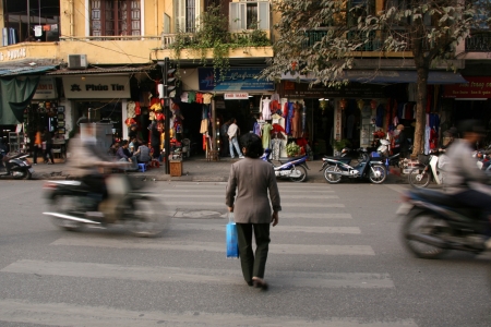 People Crossing Street in the Busy Streets of Hanoi, Vietnamのeditorial素材