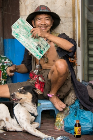 BANGKOK - FEBUARY 10 : Chinese New Year 2013 - Homeless man on street in Chinatown, Bangkok, Thailand on 10th Febuary 2013のeditorial素材
