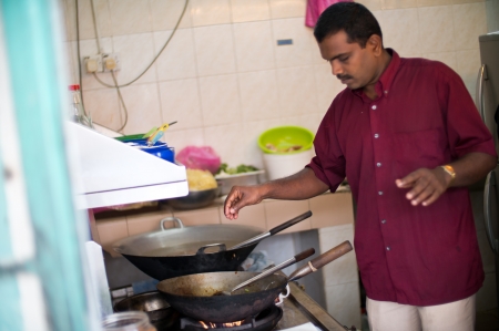 Man Cooking Local Food in Georgetown, Malaysiaのeditorial素材