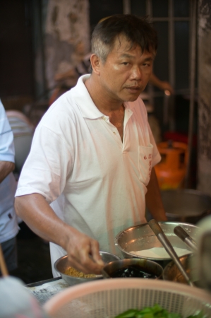 Man Cooking Local Food in Georgetown, Malaysiaのeditorial素材