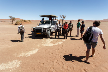 SOSSUSVLEI, NAMIBIA - NOVEMBER 2 2013: Tourists continue through the Namib Desert National Park in a year that was declared as a drought year by the government in Namibia, Africaのeditorial素材