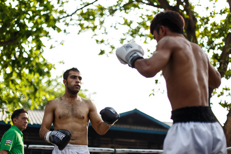 THAILAND - FEBUARY 13 2014: Prison fight / muay thai competition between international fighters and inmates within the walls of KhlongPai Prison, Thailandのeditorial素材