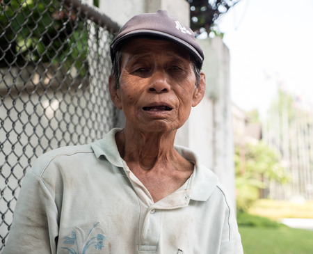 CHIANG MAI, THAILAND - APRIL 13 2015: Old man celebrates Songkran (Thai New Year Celebration). The annual water festival in Chiang Mai City, Northern Thailand.のeditorial素材