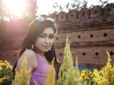 Beautiful Dark Haired Thai Asian Model Poses in Outdoor Natural Settingの写真素材