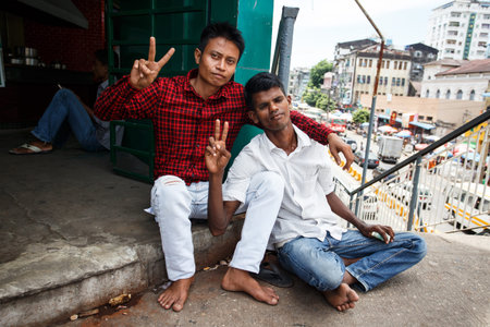 YANGON, MYANMAR - JUNE 12 2015: Local men on one of the hottest recorded days before monsoon season in Yangon, Myanmar.のeditorial素材