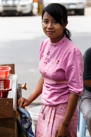 YANGON, MYANMAR - JUNE 12 2015: Lady street vendor on one of the hottest recorded days before monsoon season in Yangon, Myanmar.のeditorial素材