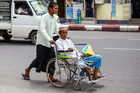 YANGON, MYANMAR - JUNE 12 2015: Disabled man on one of the hottest recorded days before monsoon season in Yangon, Myanmar.のeditorial素材