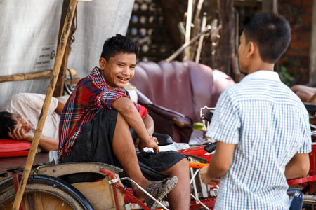 YANGON, MYANMAR - JUNE 12 2015: Trishaw drivers on one of the hottest recorded days before monsoon...