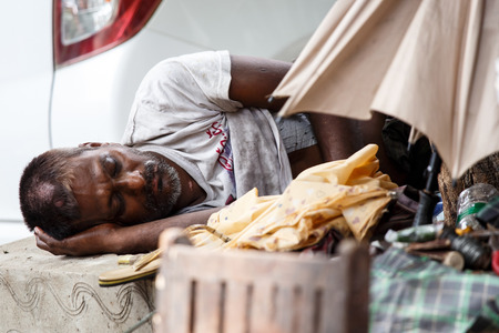 YANGON, MYANMAR - JUNE 12 2015: Homeless man sleeps on one of the hottest recorded days before monsoon season in Yangon, Myanmar.のeditorial素材