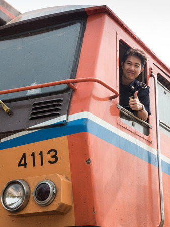MAE TAN NOI, THAILAND - MARCH 22 2015: Train Driver at remote train station Mae Tan Noi on one of the hottest recorded days in Northern Thailand.のeditorial素材