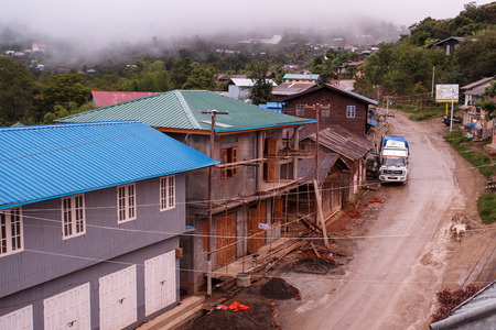TEDIM, MYANMAR - JUNE 17 2015: Street life going on in the hill village of Tedim in recently opened to tourists Chin State, Myanmar (Burma).のeditorial素材