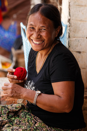 CHIN STATE, MYANMAR - JUNE 18 2015: Lady weaving with wool in the recently opened for tourists Chin State Mountainous Region, Myanmar (Burma)のeditorial素材