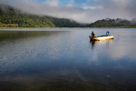 RHI LAKE, MYANMAR - JUNE 21 2015: Local fisherman on the daily fishing trip at the start of the monsoon season in the recently opened to tourists Chin State region of Western Myanmar (Burma)のeditorial素材