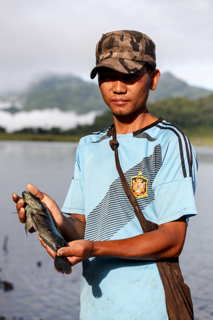 RHI LAKE, MYANMAR - JUNE 21 2015: Local fisherman on the daily fishing trip at the start of the monsoon season in the recently opened to tourists Chin State region of Western Myanmar (Burma)のeditorial素材