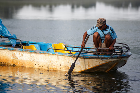 RHI LAKE, MYANMAR - JUNE 21 2015: Local fisherman on the daily fishing trip at the start of the monsoon season in the recently opened to tourists Chin State region of Western Myanmar (Burma)のeditorial素材