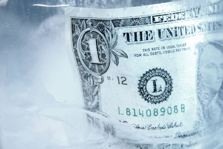 Frozen dollar in a block of iceの写真素材