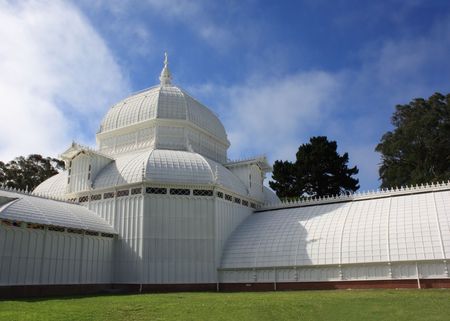 Green house white exterior on green lawnの写真素材