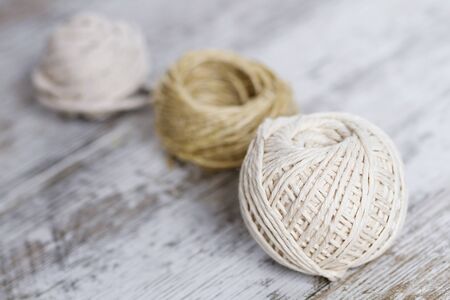 Natural fiber rope balls over a wooden backgroundの写真素材
