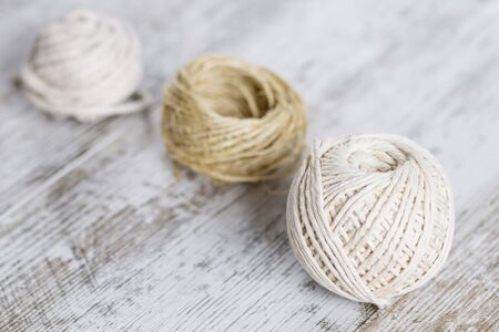 Natural fiber rope balls over a wooden backgroundの写真素材