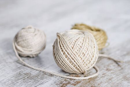 Natural fiber rope balls over a wooden backgroundの写真素材