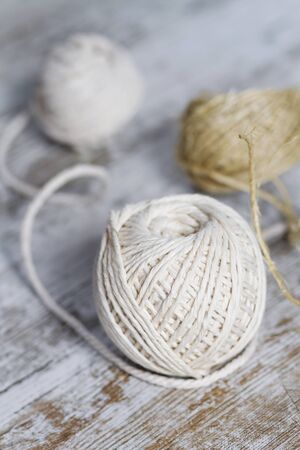 Natural fiber rope balls over a wooden backgroundの写真素材