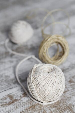 Natural fiber rope balls over a wooden backgroundの写真素材