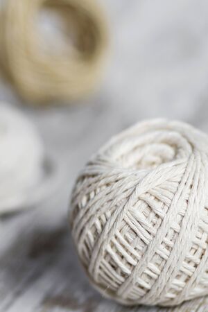Natural fiber rope balls over a wooden backgroundの写真素材