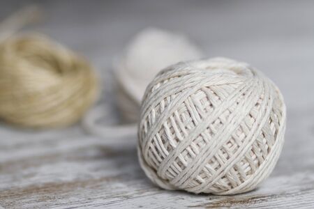 Natural fiber rope balls over a wooden backgroundの写真素材