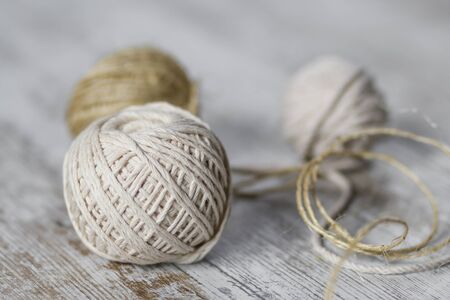 Natural fiber rope balls over a wooden backgroundの写真素材