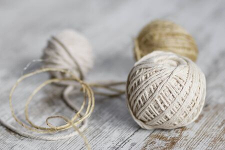 Natural fiber rope balls over a wooden backgroundの写真素材