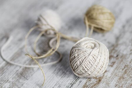 Natural fiber rope balls over a wooden backgroundの写真素材